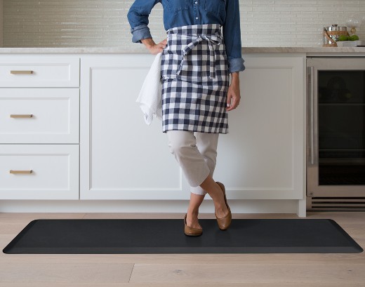 Woman standing on anti-fatigue mat